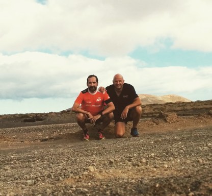 Juan and Jero in running gear in a desert landscape